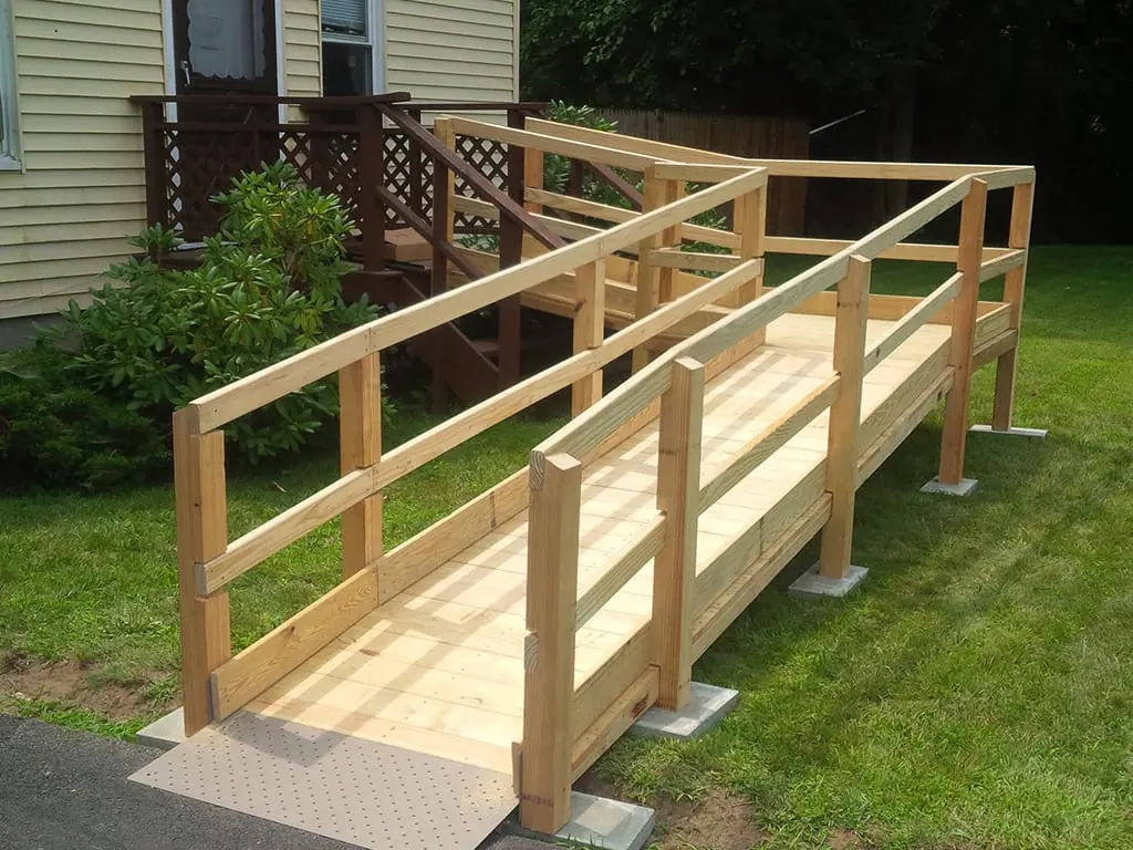 Wheelchair ramp with continuous handrails to an accessible entry